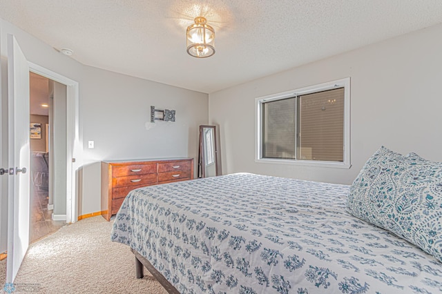 bedroom featuring carpet flooring, a textured ceiling, and baseboards