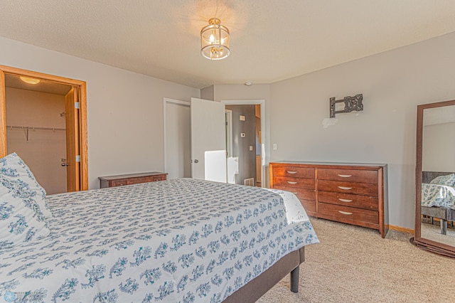 bedroom featuring light colored carpet and a textured ceiling