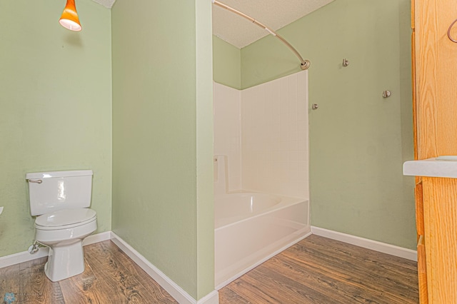 full bathroom featuring baseboards, toilet, and wood finished floors