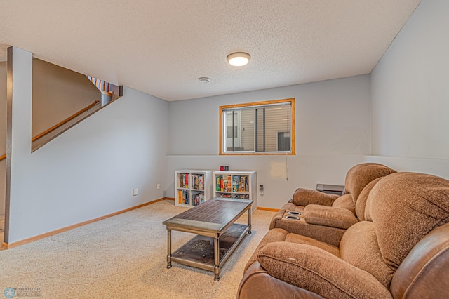 living area with carpet flooring, baseboards, a textured ceiling, and stairs