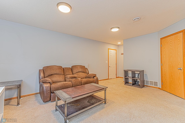 living room with baseboards, visible vents, carpet floors, and a textured ceiling