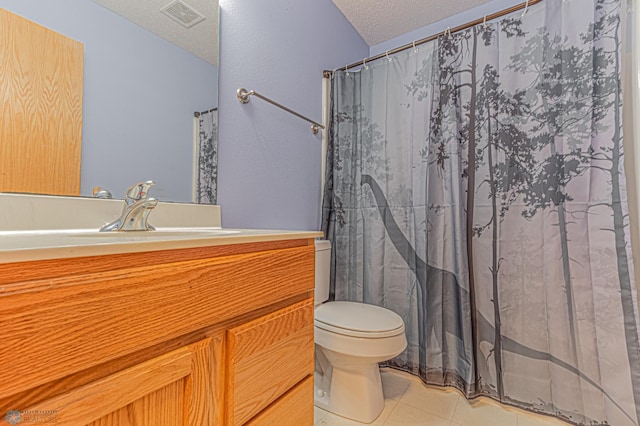 full bathroom with visible vents, toilet, vanity, tile patterned floors, and a textured ceiling