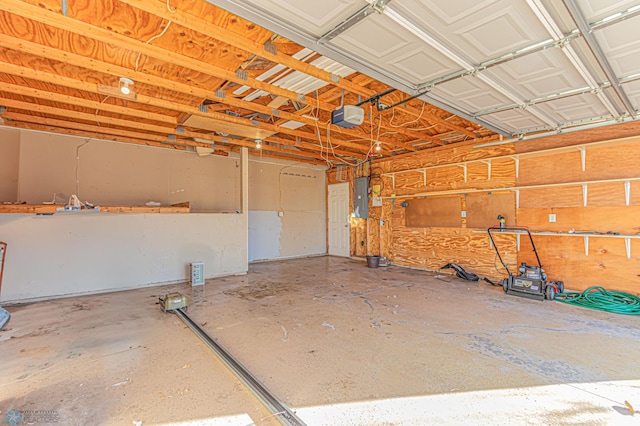 garage with electric panel and a garage door opener