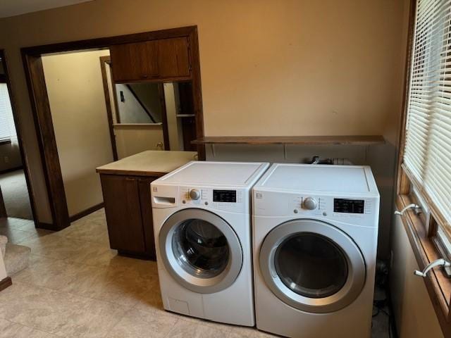 laundry area featuring cabinet space and separate washer and dryer