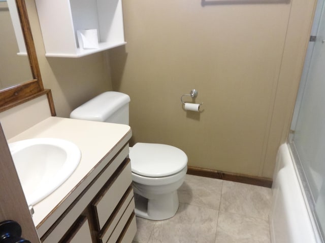 full bathroom with baseboards, toilet, and vanity