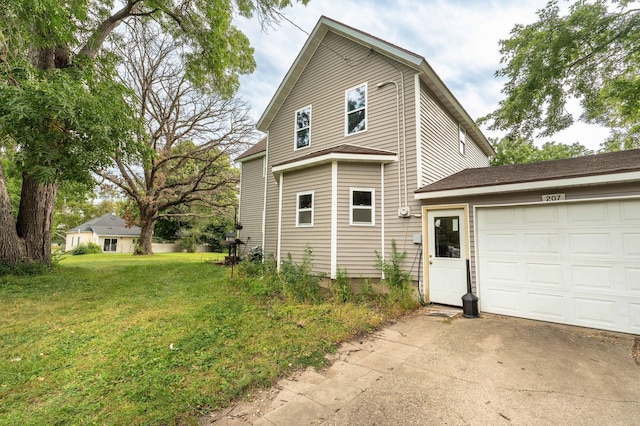 view of side of property with a lawn, an attached garage, and concrete driveway