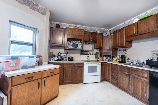 kitchen with white range with electric cooktop, a sink, black dishwasher, light countertops, and light floors