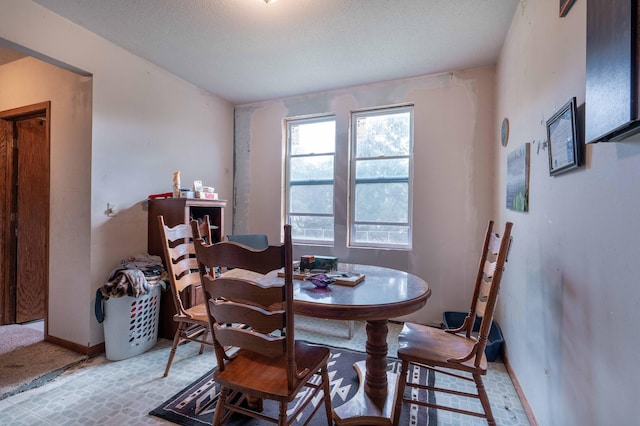 dining area featuring baseboards