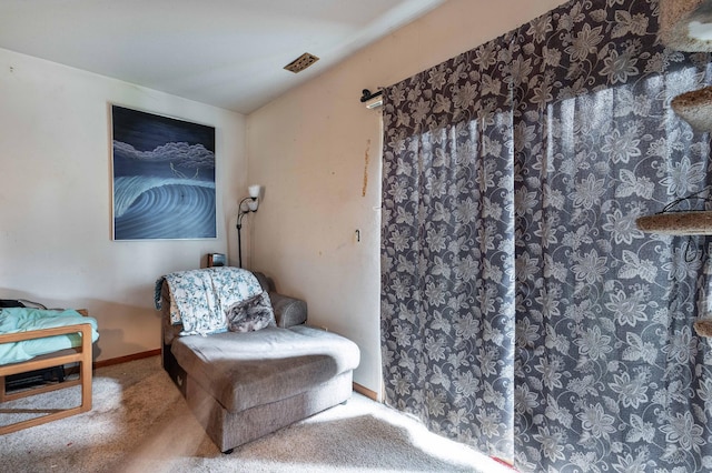 sitting room with baseboards and carpet