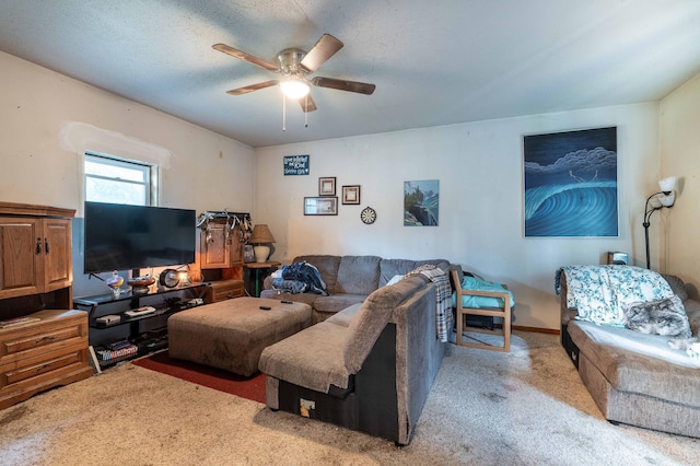 living room with a textured ceiling, ceiling fan, and carpet flooring