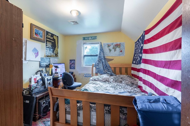 bedroom with visible vents and vaulted ceiling