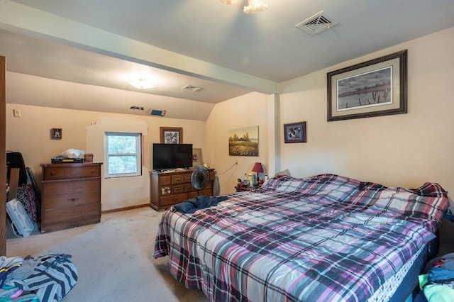 carpeted bedroom featuring lofted ceiling, baseboards, and visible vents