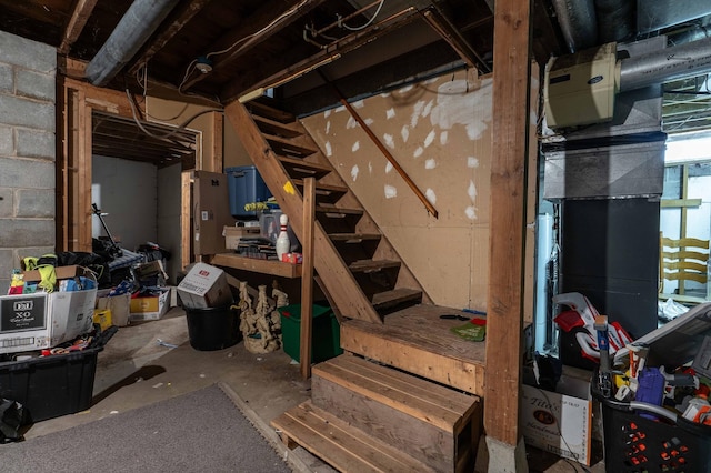 unfinished below grade area with concrete block wall and stairs