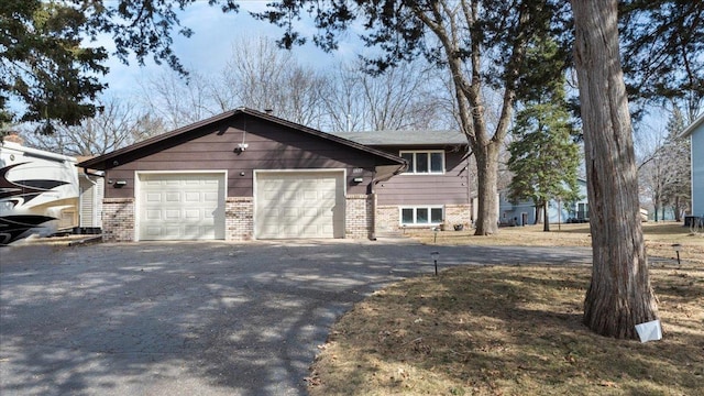 view of property exterior featuring brick siding, driveway, and a garage