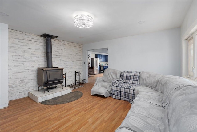 living room featuring wood finished floors and a wood stove