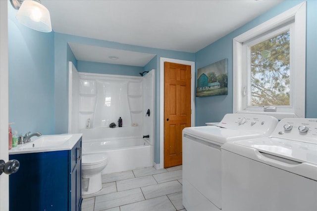 interior space featuring laundry area, washing machine and dryer, and a sink