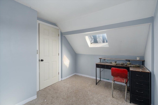 office area with lofted ceiling with skylight, baseboards, and carpet floors