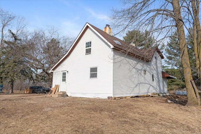 view of home's exterior featuring a chimney