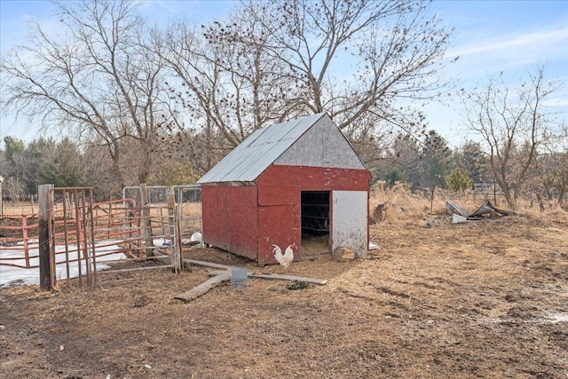 view of outbuilding featuring an outbuilding and fence