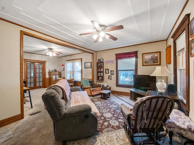 carpeted living room with a ceiling fan, visible vents, french doors, and baseboards