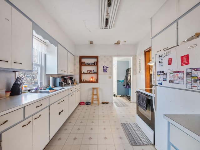 kitchen featuring a sink, white cabinetry, white appliances, light countertops, and light floors