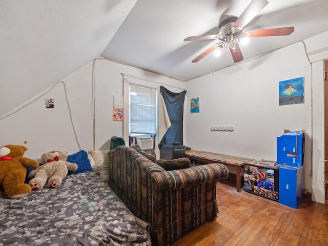 bedroom featuring vaulted ceiling, cooling unit, ceiling fan, and hardwood / wood-style floors