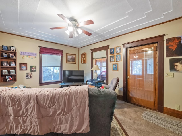 living area with baseboards, ceiling fan, and carpet flooring