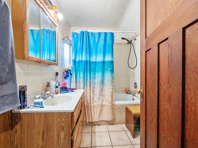 full bath featuring tile patterned floors, vanity, tile walls, and tiled shower / bath