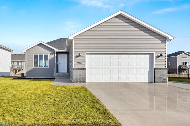 ranch-style home featuring a front lawn, an attached garage, brick siding, and driveway