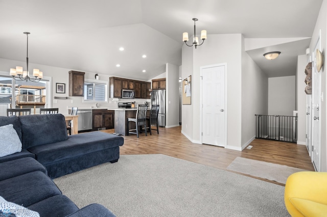 living room featuring recessed lighting, a chandelier, and light wood finished floors