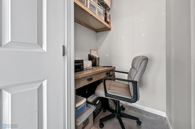 office area featuring baseboards and concrete floors