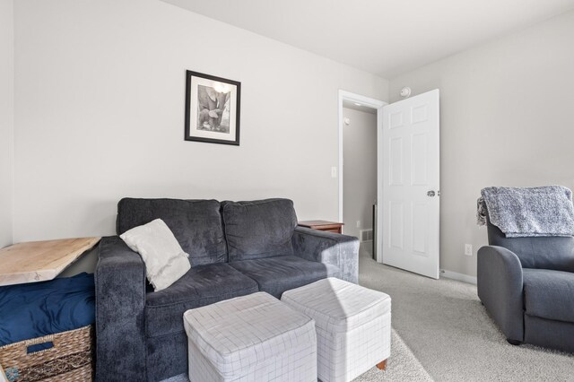 living room with light carpet and baseboards