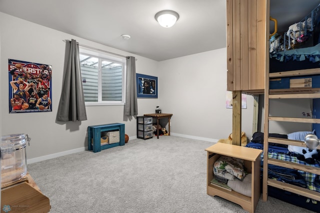 carpeted bedroom featuring baseboards