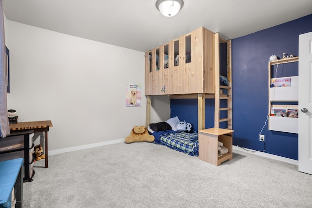 bedroom featuring carpet and baseboards