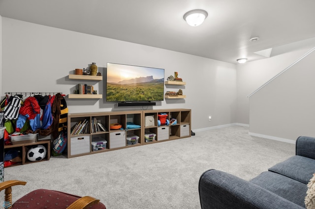 carpeted living area featuring baseboards