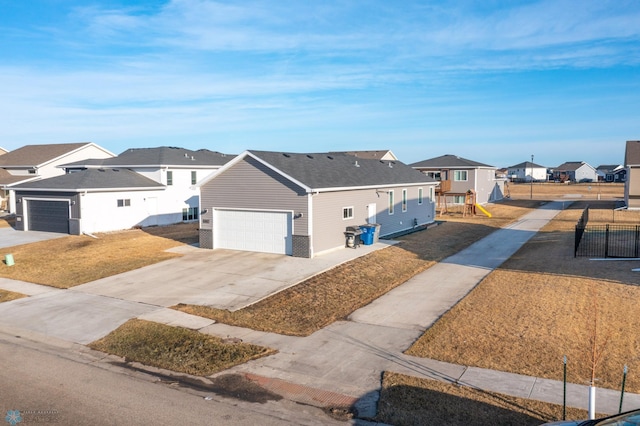 view of front of home featuring a garage, fence, and a residential view