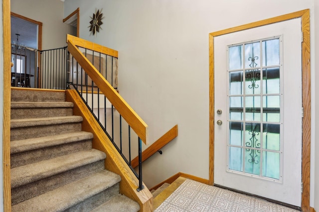 stairway with baseboards and a healthy amount of sunlight