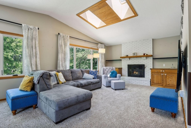 living area featuring a brick fireplace, vaulted ceiling with skylight, and carpet floors