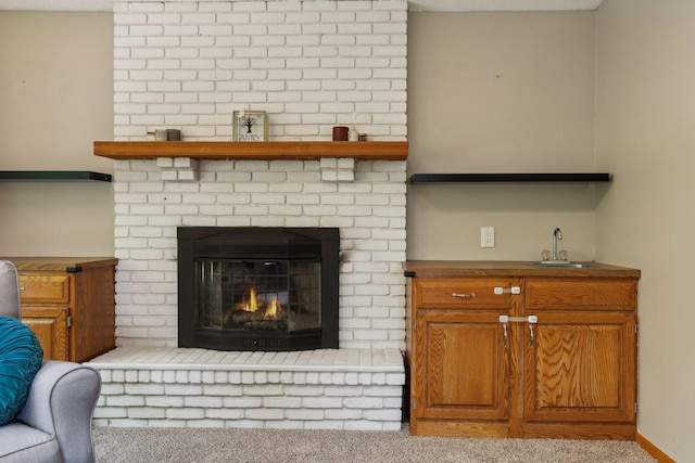 living room featuring a brick fireplace and wet bar