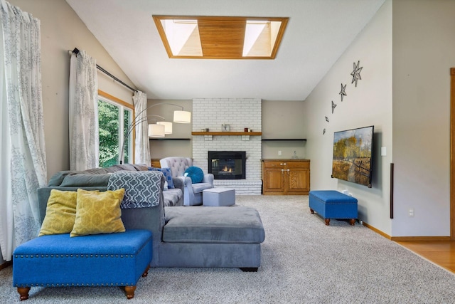 living room featuring carpet flooring, a brick fireplace, baseboards, and vaulted ceiling