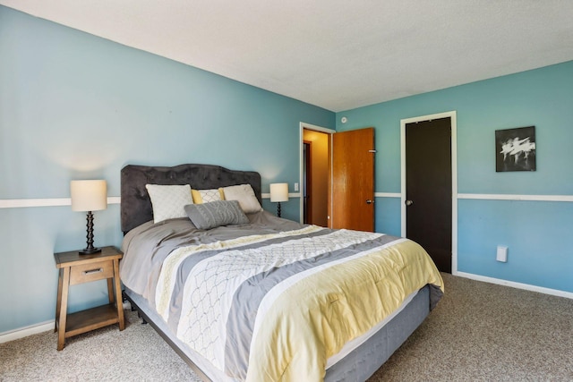 bedroom with baseboards and carpet floors