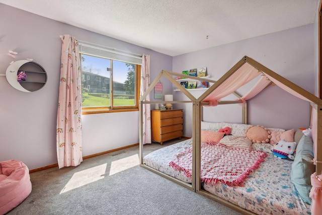 carpeted bedroom with baseboards and a textured ceiling