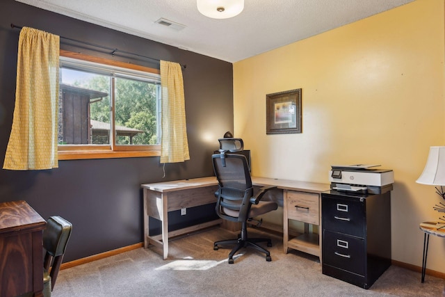 carpeted office featuring visible vents, baseboards, and a textured ceiling