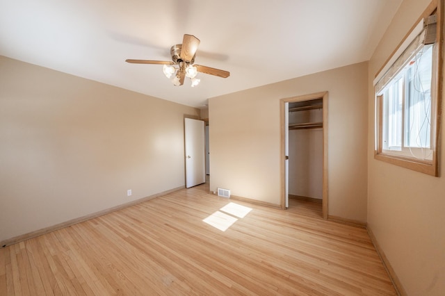 unfurnished bedroom featuring a closet, baseboards, visible vents, and light wood finished floors