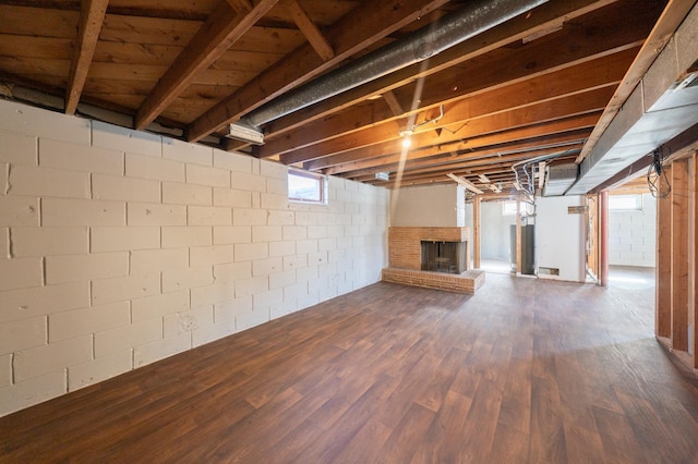 below grade area featuring dark wood-style floors and a fireplace