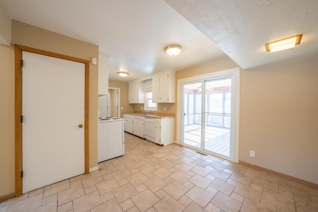 kitchen with white appliances, visible vents, light countertops, white cabinets, and a textured ceiling