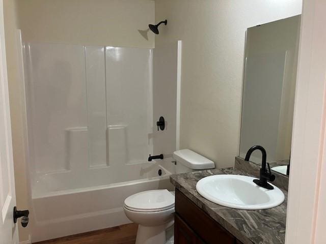 full bath with toilet, vanity, shower / bathing tub combination, and wood finished floors