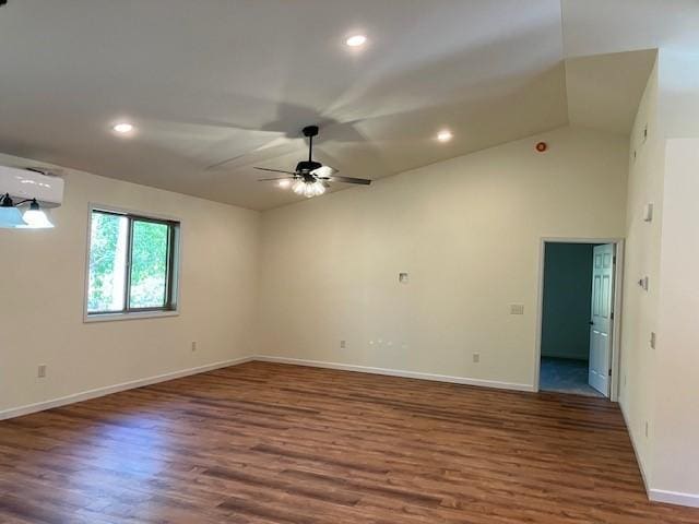 spare room featuring a wall mounted air conditioner, a ceiling fan, lofted ceiling, and wood finished floors