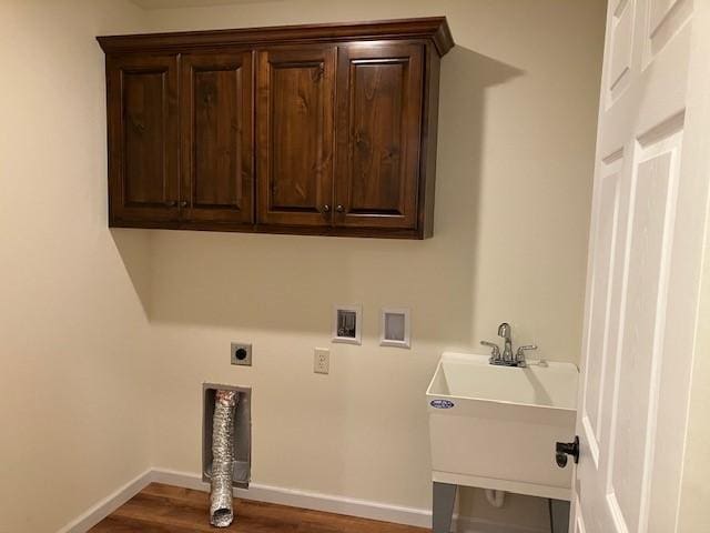 laundry room featuring washer hookup, wood finished floors, cabinet space, baseboards, and hookup for an electric dryer