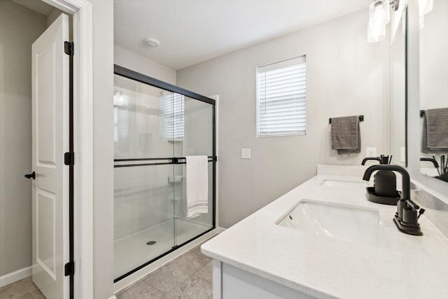 bathroom with a sink, double vanity, and a shower stall